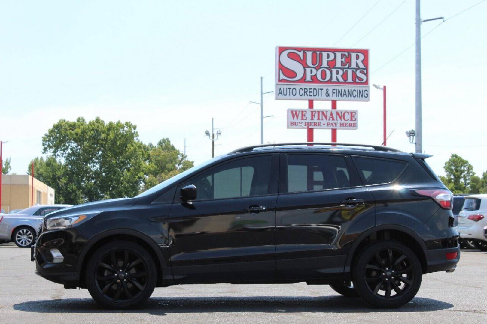 2018 Black Ford Escape SE FWD (1FMCU0GD5JU) with an 1.5L I4 Turbocharger 1.5L I4 engine, Automatic 6-Speed transmission, located at 4301 NW 39th , Oklahoma City, OK, 73112, (405) 949-5600, 35.512135, -97.598671 - NO DRIVERS LICENCE NO - FULL COVERAGE INSURANCE - NO CREDIT CHECK. COME ON OVER TO SUPERSPORTS AND TAKE A LOOK AND TEST DRIVE. PLEASE GIVE US A CALL AT (405) 949-5600. NO LICENCIA DE MANEJAR - NO SEGURO DE COBERTURA TOTAL- NO VERIFICACION DE CREDITO. POR FAVOR VENGAN A SUPERSPORTS, E- Photo#6