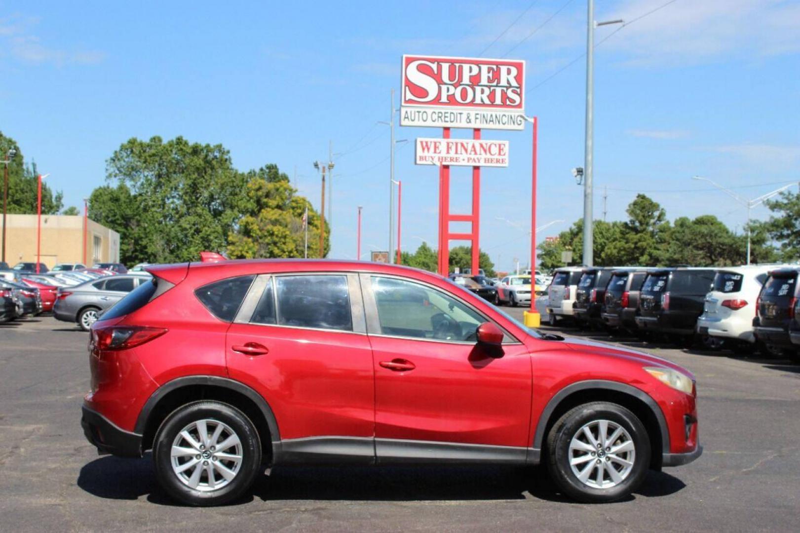 2015 Red Mazda CX-5 Touring (JM3KE2CYXF0) with an 2.5L L4 DOHC 16V engine, 6-Speed Automatic transmission, located at 4301 NW 39th , Oklahoma City, OK, 73112, (405) 949-5600, 35.512135, -97.598671 - NO DRIVERS LICENCE - NO FULL COVERAGE INSURANCE - NO CREDIT CHECK. COME ON OVER TO SUPERSPORTS AND TAKE A LOOK AND TEST DRIVE. PLEASE GIVE US A CALL AT (405) 949-5600. NO LICENCIA DE MANEJAR - NO SEGURO DE COBERTURA TOTAL - NO VERIFICACION DE CREDITO. POR FAVOR VENGAN A SUPERSPO - Photo#3