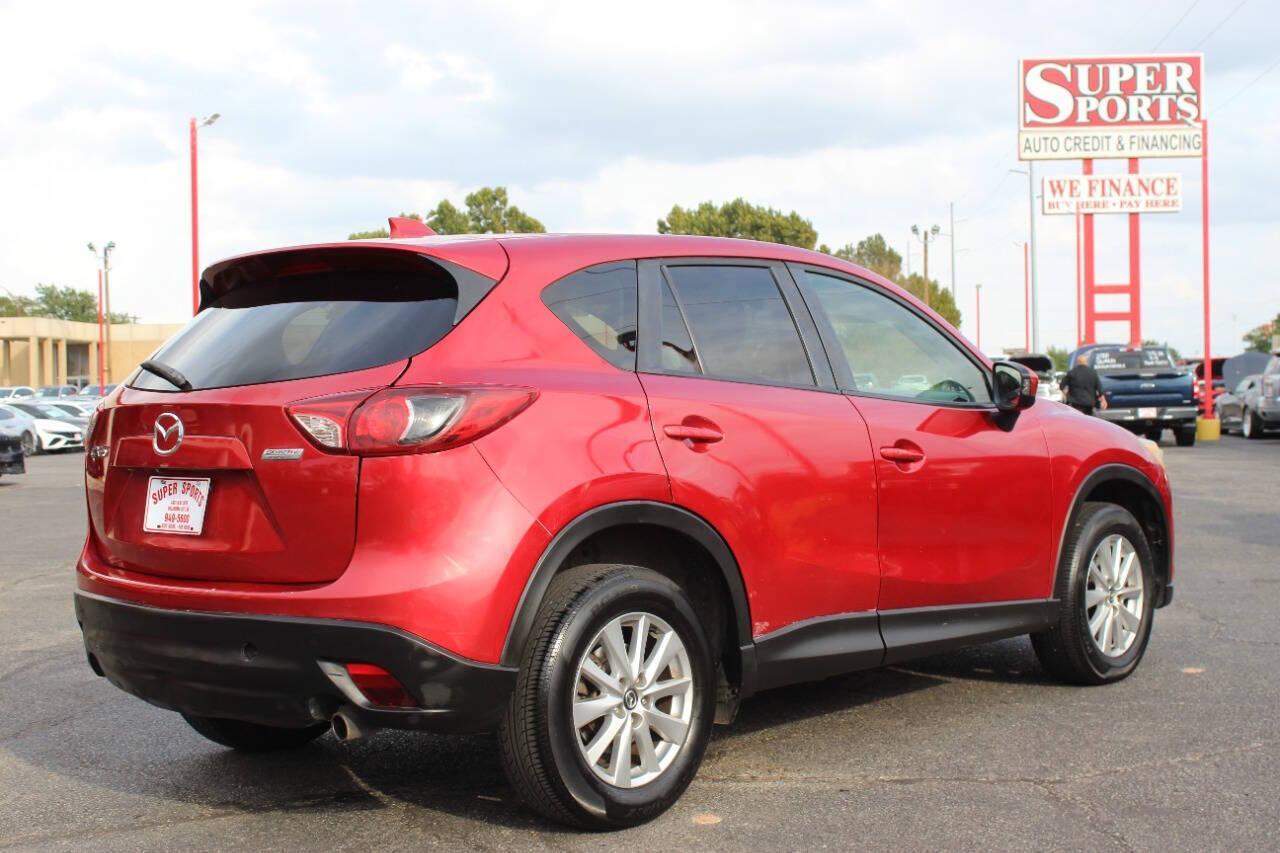 2015 Red Mazda CX-5 Touring (JM3KE2CYXF0) with an 2.5L L4 DOHC 16V engine, 6-Speed Automatic transmission, located at 4301 NW 39th , Oklahoma City, OK, 73112, (405) 949-5600, 35.512135, -97.598671 - NO DRIVERS LICENCE - NO FULL COVERAGE INSURANCE - NO CREDIT CHECK. COME ON OVER TO SUPERSPORTS AND TAKE A LOOK AND TEST DRIVE. PLEASE GIVE US A CALL AT (405) 949-5600. NO LICENCIA DE MANEJAR - NO SEGURO DE COBERTURA TOTAL - NO VERIFICACION DE CREDITO. POR FAVOR VENGAN A SUPERSPO - Photo#3