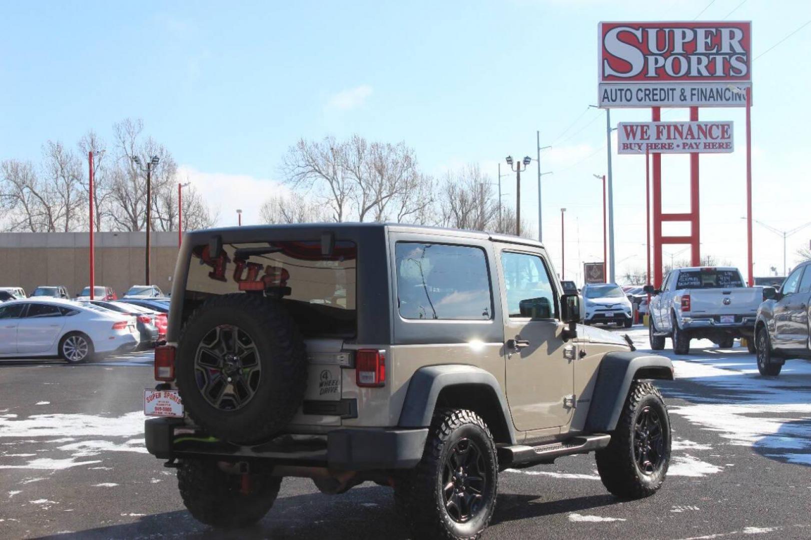 2016 Tan Jeep Wrangler Sport 4WD (1C4AJWAG7GL) with an 3.6L V6 DOHC 24V FFV engine, Automatic 5-Speed transmission, located at 4301 NW 39th , Oklahoma City, OK, 73112, (405) 949-5600, 35.512135, -97.598671 - NO DRIVERS LICENCE NO-FULL COVERAGE INSURANCE-NO CREDIT CHECK. COME ON OVER TO SUPERSPORTS AND TAKE A LOOK AND TEST DRIVE. PLEASE GIVE US A CALL AT (405) 949-5600. NO LICENSIA DE MANEJAR- NO SEGURO DE COBERTURA TOTAL- NO VERIFICACCION DE CREDITO. POR FAVOR VENGAN A SUPERSPORTS, ECHE U - Photo#4
