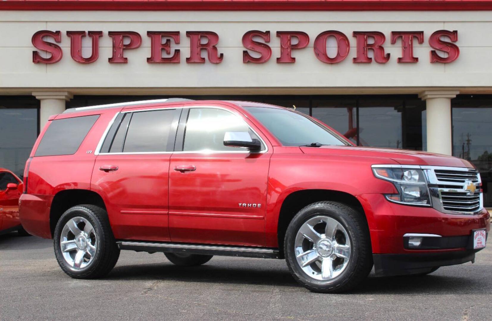2015 Red Chevrolet Tahoe LTZ 4WD (1GNSKCKC8FR) with an EcoTec3 5.3L Flex Fuel V8 355hp 383ft. lbs. 5.3L V8 engine, Automatic 6-Speed transmission, located at 4301 NW 39th , Oklahoma City, OK, 73112, (405) 949-5600, 35.512135, -97.598671- Photo#0